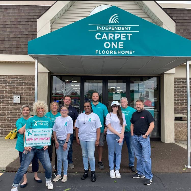Independent Carpet One team standing in front of the store proudly support a local cause.